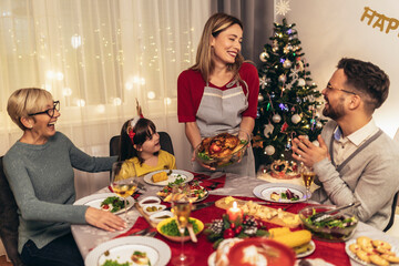 Happy multi-generation family enjoying in a lunch together at home. Family on Christmas dinner at home