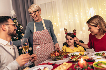 Happy multi-generation family enjoying in a lunch together at home. Family on Christmas dinner at home