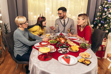 Happy multi-generation family enjoying in a lunch together at home. Family on Christmas dinner at home