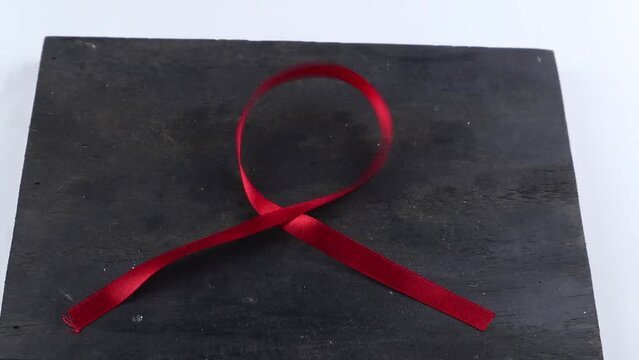 Red Support Ribbon isolated on white background. World aids day and national HIV/AIDS and aging awareness month with red ribbon