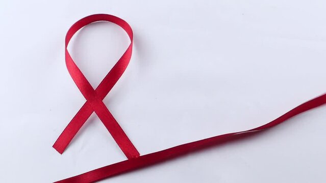Red Support Ribbon isolated on white background. World aids day and national HIV/AIDS and aging awareness month with red ribbon
