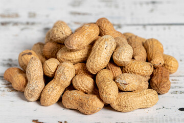 Peanut in shell on wooden background. Healthy food.