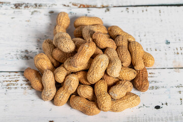 Peanut in shell on wooden background. Healthy food.