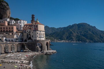 Naklejka premium Sunny summer day on the Amalfi Coast, Italy. Umberto I Square. Beautiful Italian architecture, stone houses in the mountains.