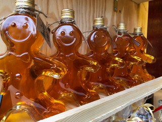 Happy face stick figure bottles filled with maple syrup