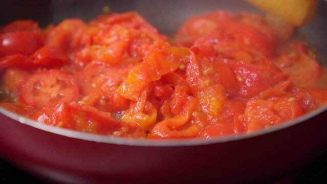 Cooking fresh tomatoes, sauce, ketchup, soup in a saucepan. Selective focus