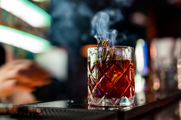glass cocktail in bar with smoke