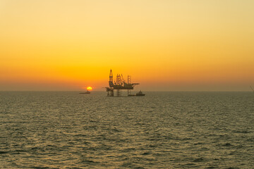 Silhouette, Offshore Jack Up Rig in The Middle of The Sea at Sunset Time