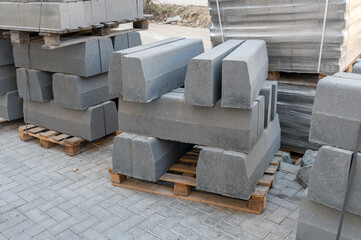 The pallets with a stack of concrete curbstone