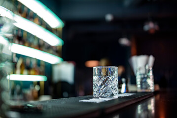 empty glass on a bar counter in bar or pub