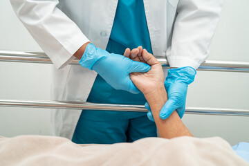 Doctor touching hands Asian senior or elderly old lady woman patient with love, care, encourage and empathy at hospital.