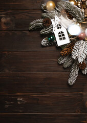 Christmas wreath on dark wooden background with copy space and bokeh. Vintage rustic festive decoration. Top view with blur and bokeh