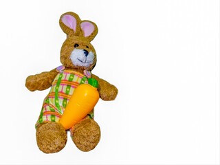 Fototapeta premium Rabbit doll with orange carrots placed on her lap.