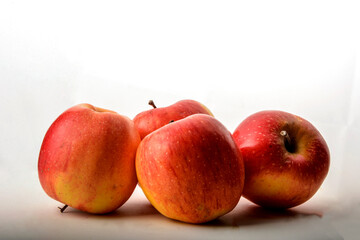 Ripe juicy red apples on white background .