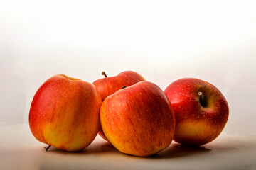 Ripe juicy red apples on white background .