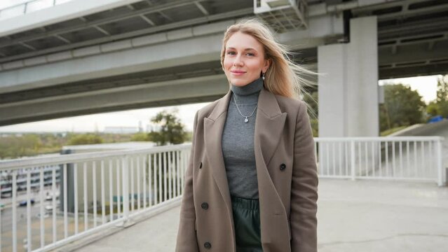 Portrait Stylish Blonde Business Woman in Long Coat. Beautiful Businesswoman Looking Confident Independent Female Executive Enjoying Successful Corporate Career. Slow Motion