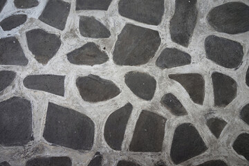 Fototapeta premium Pattern or arrangement of stones connected with concrete for vintage or abstract background