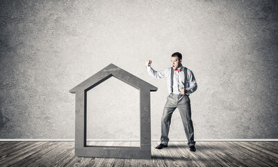 Stone home silhouette in empty room as symbol for real estate insurance