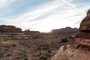 Sunset in Horse Canyon, located in the Maze District of Canyonlands National Park in Utah on a spring evening. The arid desert landscape is empty and beautiful. The sun slips behind a sandstone wall.