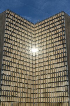 Vertical view of the Francois Mitterand library with the sun reflecting on windows in Paris, France