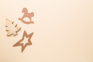 Wooden Christmas toys on color background, top view