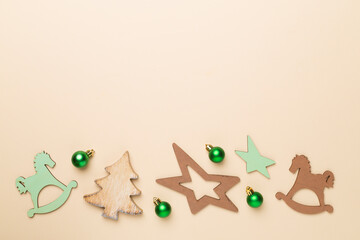 Wooden Christmas toys on color background, top view