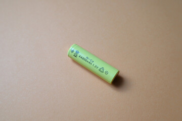 AA rechargeable batteries on orange with clipping path. Yellow batteries on a yellow pastel...