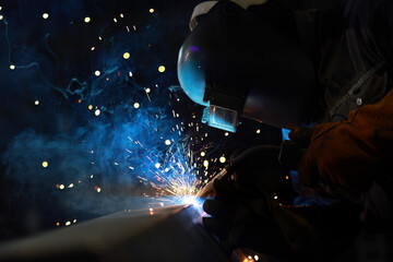 Senior worker working with welding tool