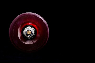 Closeup shot of an old vintage consumed skate wheel on a black background