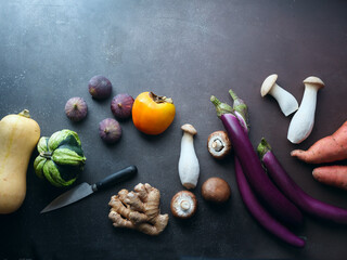 Top view winter groceries, healthy vegetarian ingredients for cooking a dinner on a dark background