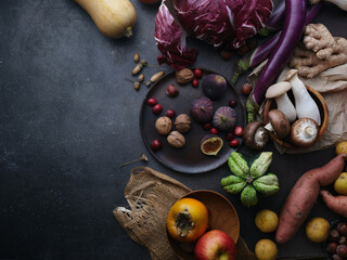 Top view winter groceries, healthy vegetarian ingredients for cooking a dinner on a dark background