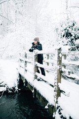 Woman on a snowy bridge in winter