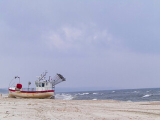 Boat on baltic sea shore. Krynica, Poland.