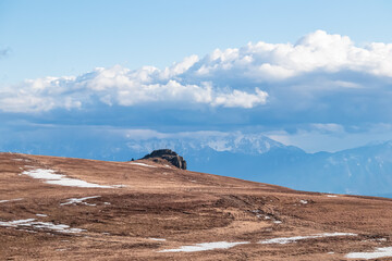 Scenic morning view after sunrise on summit cross of mountain peak Grosser Sauofen, Saualpe, Lavanttal Alps, Carinthia, Austria, Europe. Hiking trail in Wolfsberg. Karawanks mountains in the back