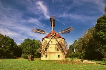 Fototapeta na wymiar The windmill Svetlik at the meadow near Krasna Lipa, Czech republic