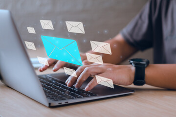 concept,technology Online marketing with email to reach customers, male hand typing on laptop keyboard with envelope icon showing reply to customer by e-mail, communication between buyer and seller - obrazy, fototapety, plakaty