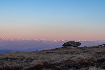 Scenic view of unique rock formation and Karawanks mountains seen from an alpine meadow near...