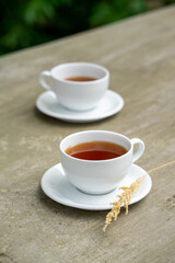 Minimalist tea is served on the concrete table.