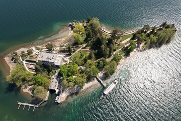 Aerial top view of a small island with buildings and trees