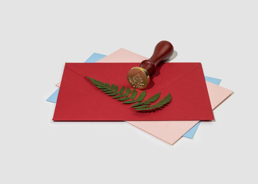 Wax printing with fire paint on envelope with pressed dried fern leaf. Homemade christmas greeting card. Vintage style decor.