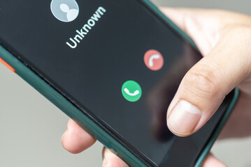 Man holding mobile Phone call from unknown number. Scam, fraud or phishing with smartphone concept....