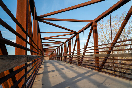 bike trail and a long footbridge over a river - South Platte River Trail near Brighton, Colorado