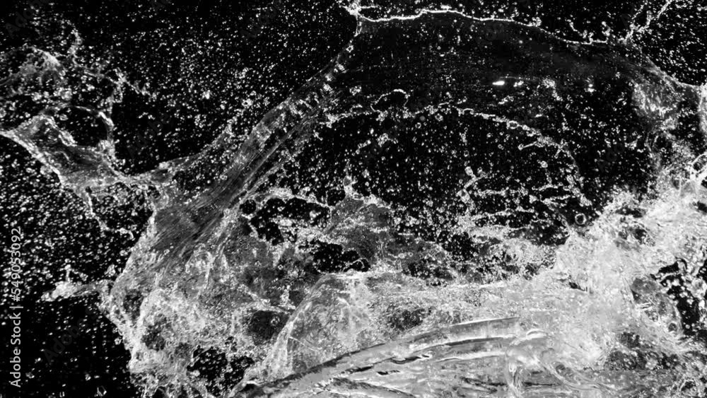 Poster super slow motion of water splashes in collision, isolated on black background. filmed on high speed
