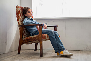 Fototapeta premium A young girl posing against the wall