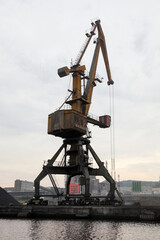 Fototapeta na wymiar Silhouette of portal crane, close-up vertical photo