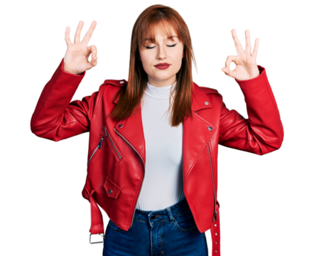 Redhead young woman wearing red leather jacket relax and smiling with eyes closed doing meditation gesture with fingers. yoga concept. - Powered by Adobe