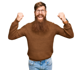 Young irish redhead man wearing casual clothes and glasses angry and mad raising fists frustrated and furious while shouting with anger. rage and aggressive concept.