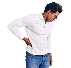 Handsome african american man with afro hair wearing casual clothes and glasses suffering of backache, touching back with hand, muscular pain