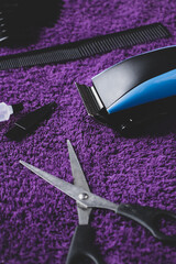 Men's hair clipper kit with scissors, comb and leaning equipment. Men's grooming products.
