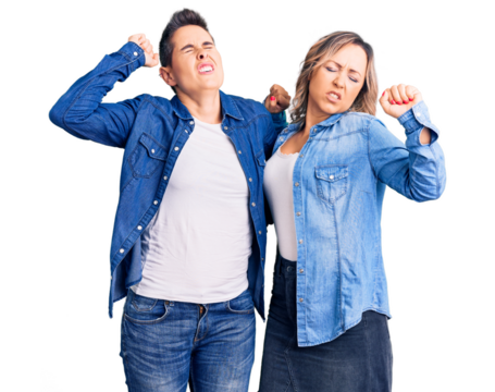 Couple of women wearing casual clothes stretching back, tired and relaxed, sleepy and yawning for early morning